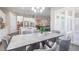 Bright dining room featuring modern table and chairs adjacent to the kitchen area, and shuttered windows at 26722 E Peakview Pl, Aurora, CO 80016