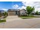 Beautiful exterior featuring a two-car garage, stone accents, and a well-manicured lawn at 26722 E Peakview Pl, Aurora, CO 80016