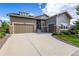 Charming home with a two-car garage, stone accents, and a well-manicured lawn and driveway at 26722 E Peakview Pl, Aurora, CO 80016