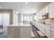 Spacious modern kitchen with white cabinets, large island, stainless appliances, and plenty of natural light at 26722 E Peakview Pl, Aurora, CO 80016