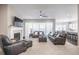 Bright living room with a fireplace, plush seating, and seamless flow to the kitchen and dining area at 26722 E Peakview Pl, Aurora, CO 80016