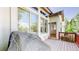View of the rear exterior of the home with access to the back deck, large windows, and abundant natural light at 6187 Reed Way, Arvada, CO 80003