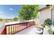 Relaxing back deck featuring a comfortable outdoor seating area with an unobstructed view of the lush, green exterior at 6187 Reed Way, Arvada, CO 80003