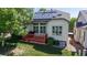 Back exterior with solar panels, a cozy deck with red rails, and a well-maintained backyard at 6187 Reed Way, Arvada, CO 80003