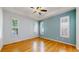 Bright bedroom with hardwood floors, tray ceiling, and plentiful light from shuttered windows at 6187 Reed Way, Arvada, CO 80003