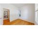 Empty bedroom with hardwood floors and lots of natural light streaming in at 6187 Reed Way, Arvada, CO 80003