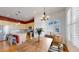 Dining room with a modern chandelier and lots of natural light flowing into the kitchen area at 6187 Reed Way, Arvada, CO 80003
