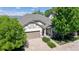 Aerial front exterior featuring great curb appeal, a well-manicured lawn, and an attached two-car garage at 6187 Reed Way, Arvada, CO 80003