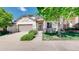 Charming front exterior featuring stone accents, a well-manicured lawn, and an attached two-car garage at 6187 Reed Way, Arvada, CO 80003