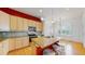 Kitchen area with an island, modern stainless steel appliances, and seating for guests at 6187 Reed Way, Arvada, CO 80003