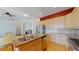 Open kitchen area with a large island, seamlessly connected to the living room with hardwood floors at 6187 Reed Way, Arvada, CO 80003