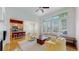 Bright living room flows into kitchen with hardwood floors, and a ceiling fan above at 6187 Reed Way, Arvada, CO 80003