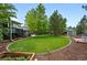 Beautifully landscaped backyard with lush lawn, mature trees, garden shed and privacy fencing at 9315 Field Ln, Westminster, CO 80021