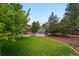 Wide shot of the backyard showing large lawn, garden beds, and storage shed at 9315 Field Ln, Westminster, CO 80021