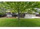 Spacious backyard with lush lawn, mature trees, and access to a deck, perfect for relaxation at 9315 Field Ln, Westminster, CO 80021