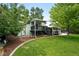 Exterior shot of backyard with lush lawn, patio, and upper deck off of the home at 9315 Field Ln, Westminster, CO 80021
