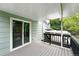 View of the covered deck with wooden floors and black railings, perfect for relaxing outside at 9315 Field Ln, Westminster, CO 80021
