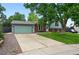 Charming home featuring a two-car garage, lush lawn, mature trees, and a brick and siding facade at 9315 Field Ln, Westminster, CO 80021
