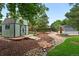 A view of the quaint garden shed surrounded by mulch and other garden features at 9315 Field Ln, Westminster, CO 80021