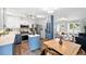 Eat-in kitchen features stainless appliances, an island, white and blue cabinets, and modern fixtures at 9315 Field Ln, Westminster, CO 80021