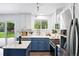 Well-lit kitchen featuring stainless appliances, sleek countertops, and a view of the yard from the window at 9315 Field Ln, Westminster, CO 80021