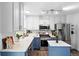 Bright kitchen featuring white cabinets, stainless steel appliances, and an island with stylish blue accent at 9315 Field Ln, Westminster, CO 80021