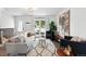 Bright living room with modern decor, hardwood floors, stylish furniture, and an open concept layout at 9315 Field Ln, Westminster, CO 80021