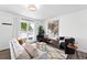Bright living room with modern decor, hardwood floors, stylish furniture, and an open concept layout at 9315 Field Ln, Westminster, CO 80021