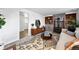 Open living area featuring a brick fireplace, a stylish rug, and wood accents at 9315 Field Ln, Westminster, CO 80021
