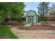 Exterior photo of a backyard shed with black trim and a small wooden bridge at 9315 Field Ln, Westminster, CO 80021