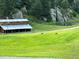 Rural scene with a rustic barn, pond, and turkeys grazing on a lush green lawn at 60 N County Highway 67, Sedalia, CO 80135