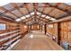 Barn interior with wooden beams and a large open space, featuring windows and shelving at 60 N County Highway 67, Sedalia, CO 80135