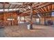 Rustic barn interior with wood beams, ladder, and open space perfect for animals or storage at 60 N County Highway 67, Sedalia, CO 80135