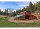 Rustic barn with a unique design, featuring an attached greenhouse structure in a rural landscape setting at 60 N County Highway 67, Sedalia, CO 80135
