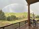 View of the wooded property and rainbow from the covered deck at 60 N County Highway 67, Sedalia, CO 80135