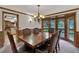 Formal dining room featuring a wood dining table, wainscoting, and stylish chandelier at 60 N County Highway 67, Sedalia, CO 80135