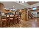 Traditional kitchen featuring custom wood cabinetry, island seating and an open floor plan at 60 N County Highway 67, Sedalia, CO 80135