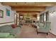 Cozy living room with a stone fireplace, wood ceiling beams, and built-in shelving at 60 N County Highway 67, Sedalia, CO 80135