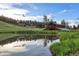 Picturesque pond reflecting the log cabin, barn and partly cloudy sky at 60 N County Highway 67, Sedalia, CO 80135