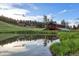 Scenic pond reflecting the sky and trees, nestled in a landscape with a charming building in the background at 60 N County Highway 67, Sedalia, CO 80135