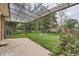 A covered patio offers views of a fenced backyard with vibrant flowers and ample space for outdoor activities at 1325 Geneva St, Aurora, CO 80010