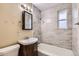 Bathroom with a vanity sink and tiled shower and walls at 1325 Geneva St, Aurora, CO 80010