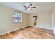 Cozy bedroom featuring hardwood floors, a ceiling fan, and a view of the neighborhood at 1325 Geneva St, Aurora, CO 80010