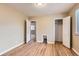 Bright, empty bedroom with multiple doors and hardwood floors at 1325 Geneva St, Aurora, CO 80010