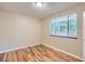 An empty bedroom with hardwood floors and a window with blinds at 1325 Geneva St, Aurora, CO 80010