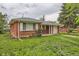 Charming red brick home featuring a well-manicured lawn and an attached one car garage at 1325 Geneva St, Aurora, CO 80010
