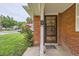 Home featuring a secure black metal door, a lush rose bush, and green lawn at 1325 Geneva St, Aurora, CO 80010