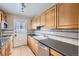 Kitchen featuring tile floors, bright cabinets, and modern appliances at 1325 Geneva St, Aurora, CO 80010
