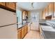 Clean kitchen with bright cabinets, tile floors, and modern appliances at 1325 Geneva St, Aurora, CO 80010