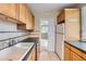 Cozy kitchen featuring bright wooden cabinets and a tiled backsplash with tiled floors at 1325 Geneva St, Aurora, CO 80010